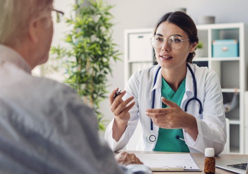 Doctor and patient are discussing at clinic Doctor and patient are discussing at clinic